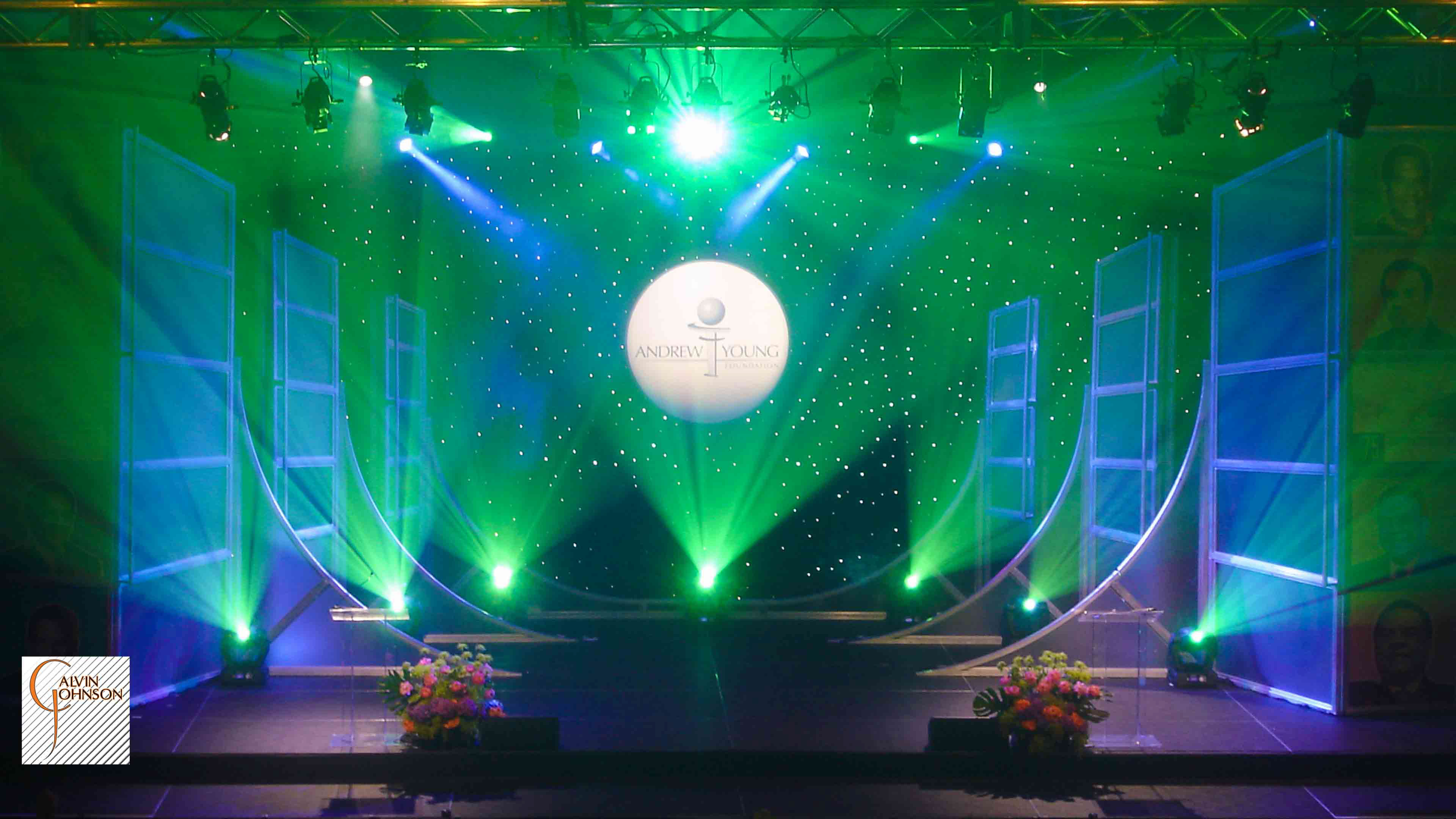 Beams of Green and White Light Shining from a stage