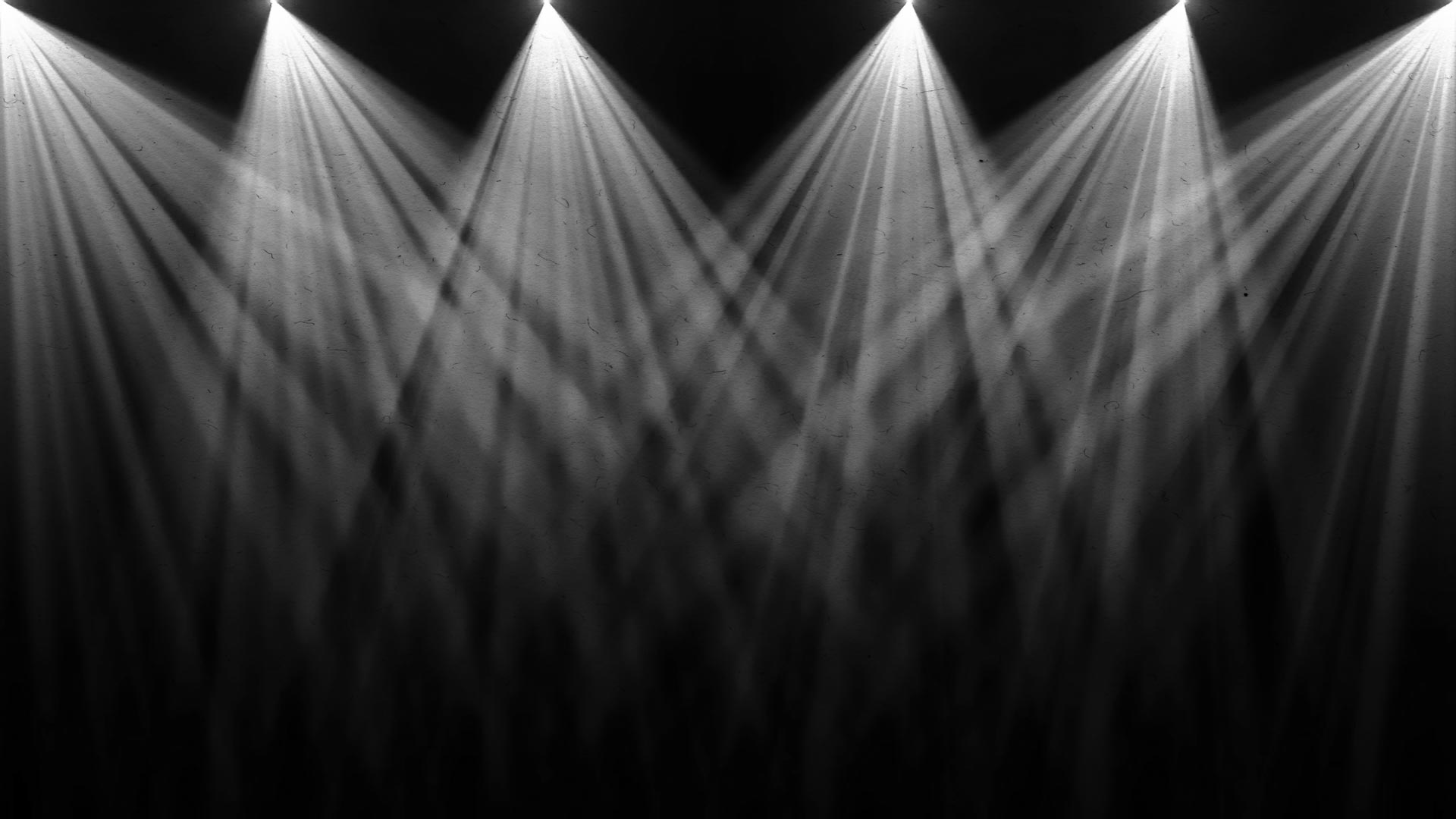 Fractured beams of light shinning from above thru haze.