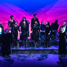 Choral members singing a musical number on stage from The Black Nativity Play.