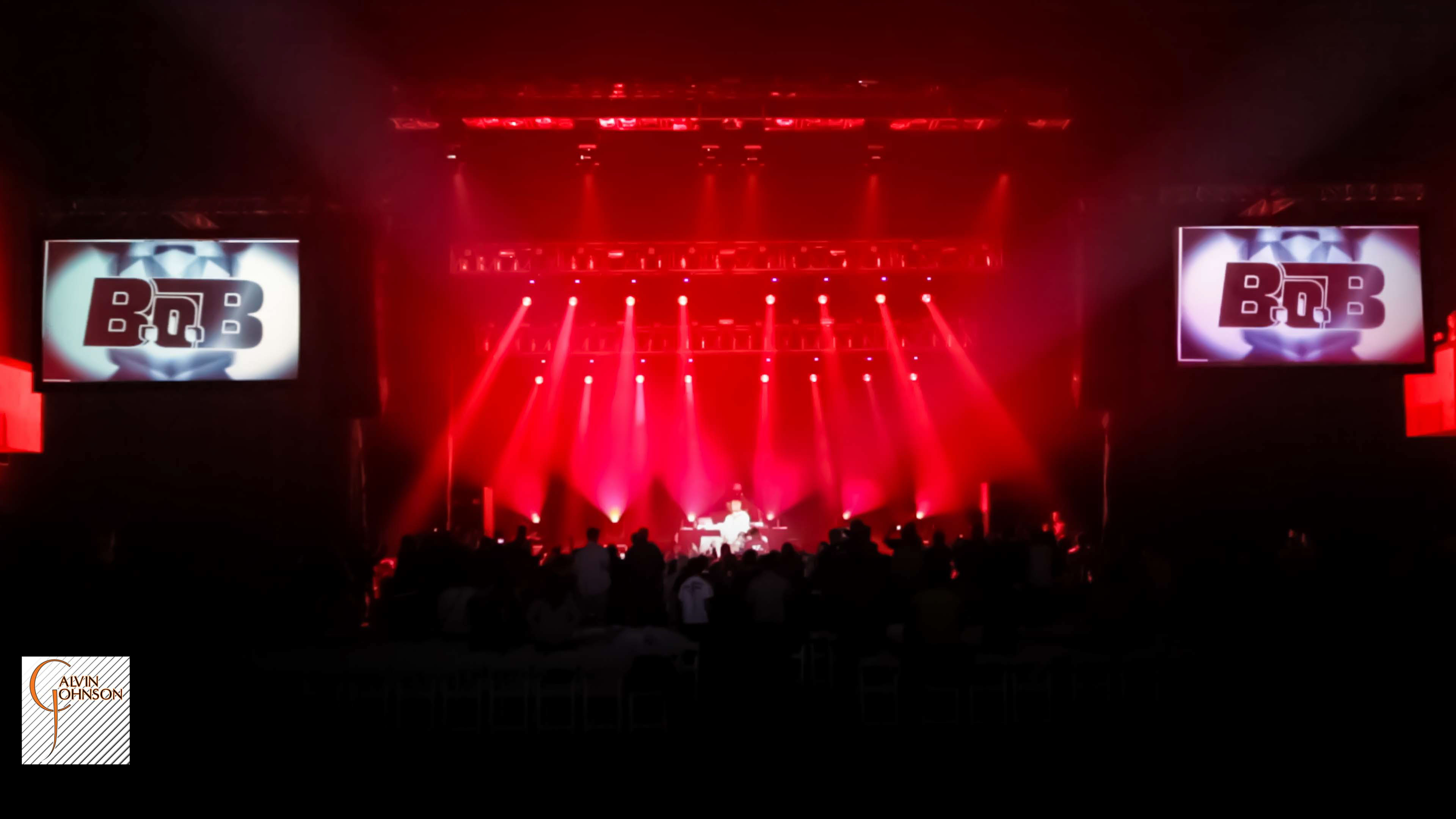 Hip Hop artist B.o.B performing at a concert with DJ Shawty Slim.