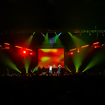 Red lighting and smoke surrounding Young Jeezy at his concert at North Carolina A&T