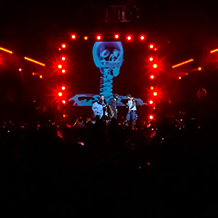 Red lighting and smoke surrounding Young Jeezy at his concert at North Carolina A&T